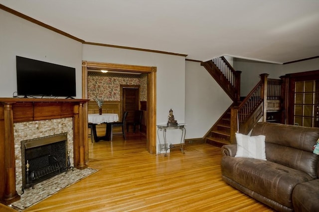 10 Dorchester, Springfield, MA 01109 - living room with light wood-style flooring, crown molding, stairs, baseboards, and a fireplace with flush hearth