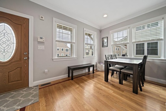 867 Adams St Unit 867, Boston, MA 02124 - dining room featuring baseboards, light wood-style floors, and crown molding