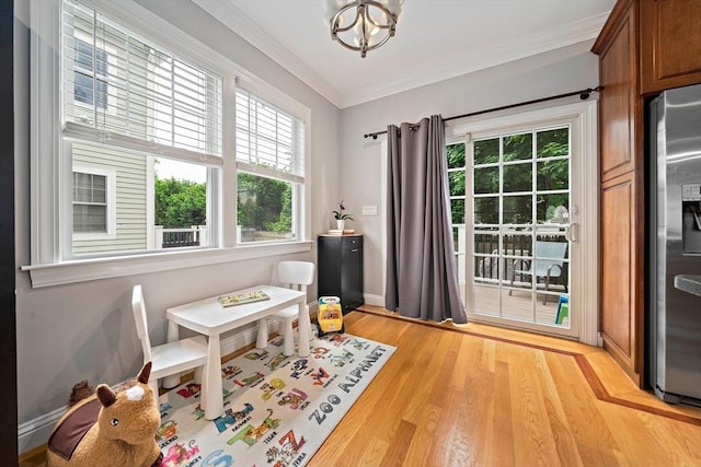 867 Adams St Unit 867, Boston, MA 02124 - dining room with healthy amount of natural light, a chandelier, light wood-style flooring, and ornamental molding