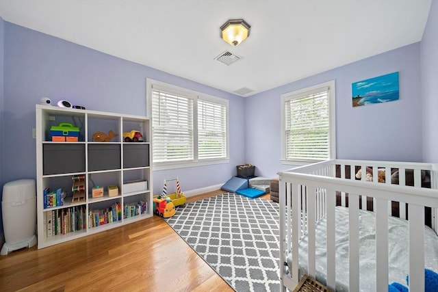 867 Adams St Unit 867, Boston, MA 02124 - bedroom featuring wood finished floors, multiple windows, and baseboards