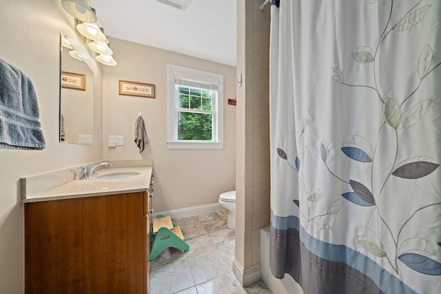 867 Adams St Unit 867, Boston, MA 02124 - full bath with vanity, toilet, baseboards, marble look tiles, and shower / bath combo