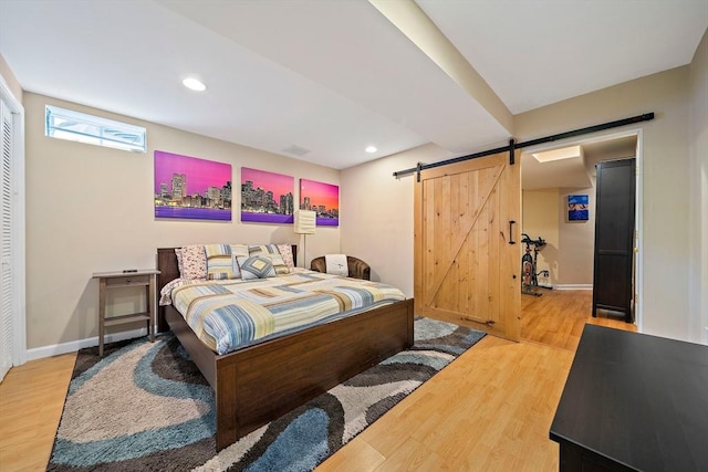 867 Adams St Unit 867, Boston, MA 02124 - bedroom with a barn door, wood finished floors, recessed lighting, and baseboards