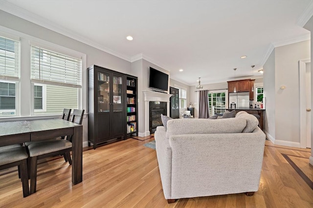 867 Adams St Unit 867, Boston, MA 02124 - living area with a glass covered fireplace, baseboards, crown molding, recessed lighting, and light wood-style floors