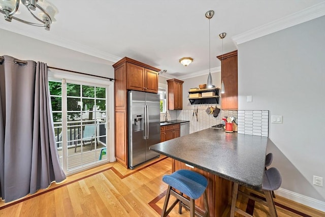 867 Adams St Unit 867, Boston, MA 02124 - kitchen featuring stainless steel appliances, dark countertops, a breakfast bar, a peninsula, and backsplash