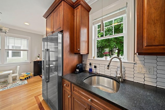 867 Adams St Unit 867, Boston, MA 02124 - kitchen with stainless steel fridge with ice dispenser, a sink, plenty of natural light, ornamental molding, and hanging light fixtures