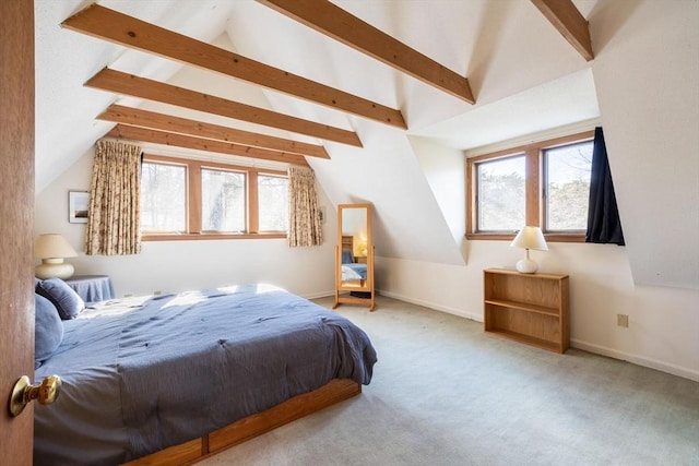 bedroom featuring multiple windows, lofted ceiling with beams, and carpet