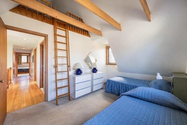 bedroom with beam ceiling and light carpet