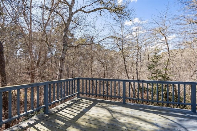 wooden deck featuring a forest view