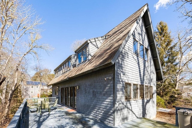 view of property exterior with a deck