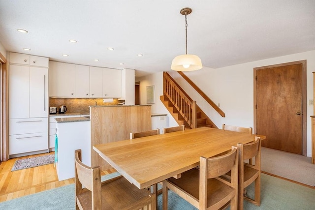 dining room featuring stairs, recessed lighting, and light wood-style floors