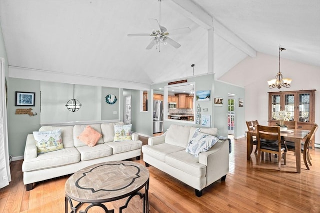 living room featuring light wood-style flooring, ceiling fan with notable chandelier, high vaulted ceiling, baseboards, and beamed ceiling