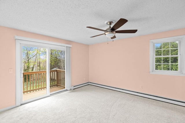 spare room with ceiling fan, a wealth of natural light, and carpet flooring