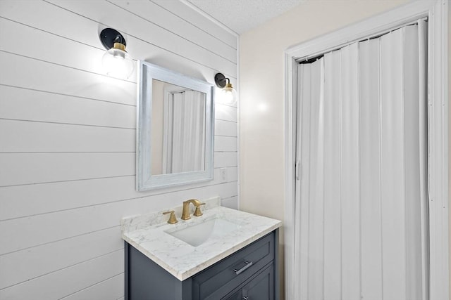 bathroom with wooden walls and vanity