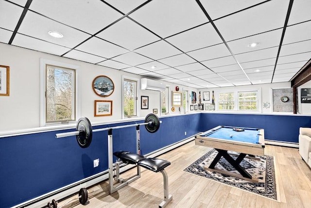 game room with a baseboard heating unit, wood finished floors, pool table, a baseboard radiator, and a wall mounted AC