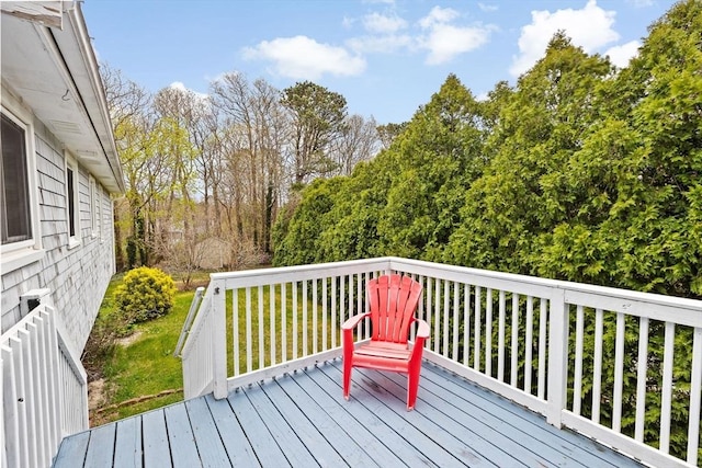 wooden deck with a lawn