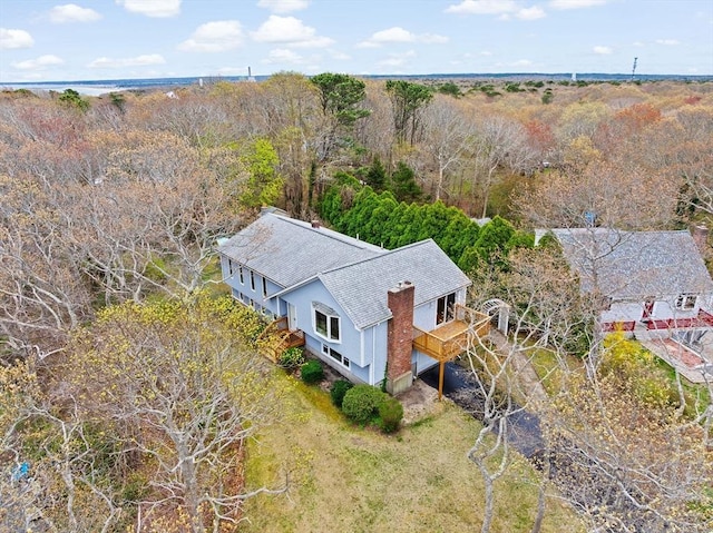 birds eye view of property featuring a wooded view