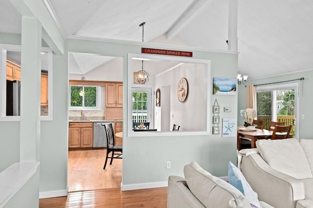 interior space with lofted ceiling with beams, light wood finished floors, and an inviting chandelier