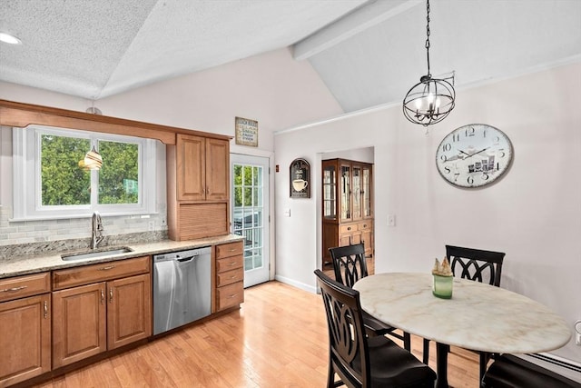 kitchen featuring a sink, brown cabinets, light wood-type flooring, dishwasher, and decorative backsplash