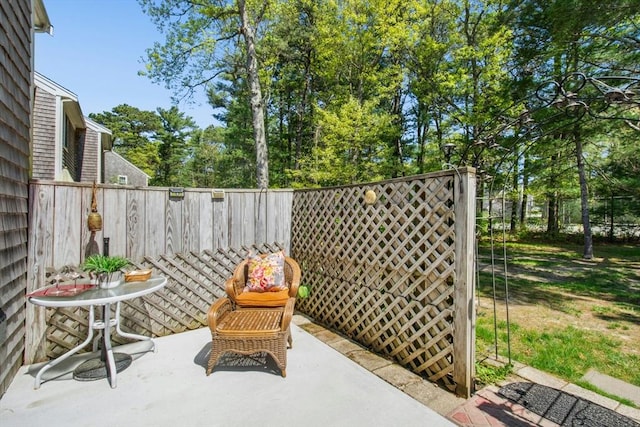 300 Falmouth Rd Unit 12E, Mashpee, MA 02649 - view of patio with fence and view of scattered trees