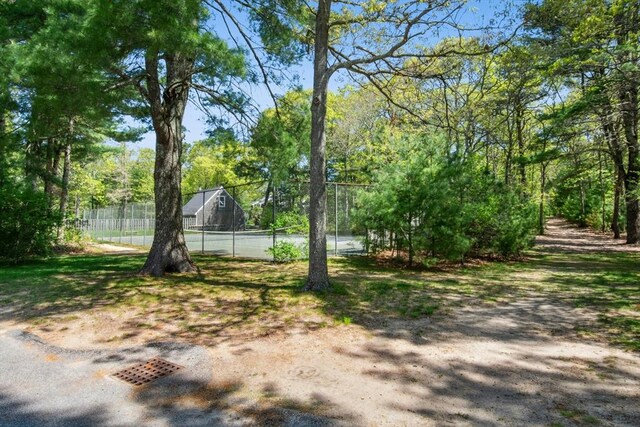 300 Falmouth Rd Unit 12E, Mashpee, MA 02649 - view of yard featuring fence and a tennis court