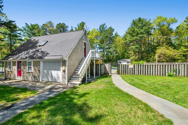 300 Falmouth Rd Unit 12E, Mashpee, MA 02649 - view of home's exterior featuring stairs, a shingled roof, and a garage
