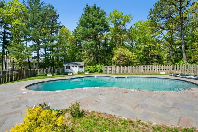 300 Falmouth Rd Unit 12E, Mashpee, MA 02649 - view of swimming pool with a patio, a fenced backyard, an outdoor structure, and a shed