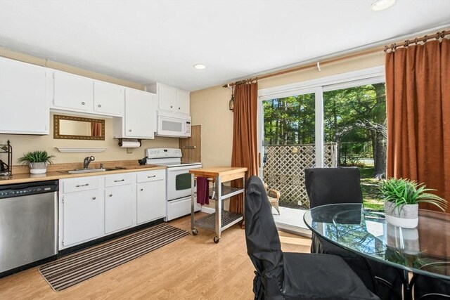 300 Falmouth Rd Unit 12E, Mashpee, MA 02649 - kitchen with white appliances, a sink, light wood-style flooring, light countertops, and white cabinets