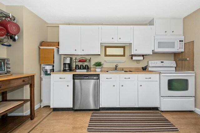 300 Falmouth Rd Unit 12E, Mashpee, MA 02649 - kitchen featuring white appliances, a sink, light wood finished floors, white cabinets, and light countertops
