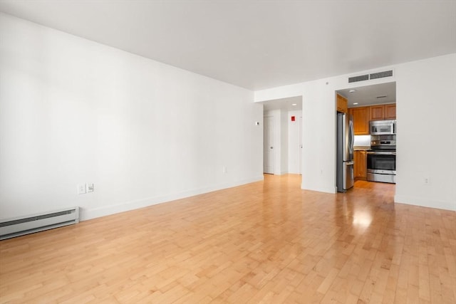 unfurnished living room with light hardwood / wood-style floors and baseboard heating