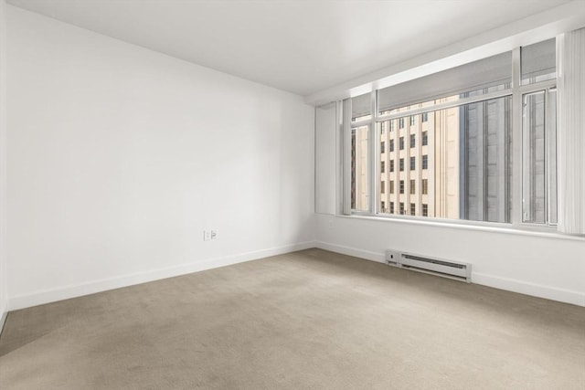 empty room with carpet flooring and a baseboard radiator