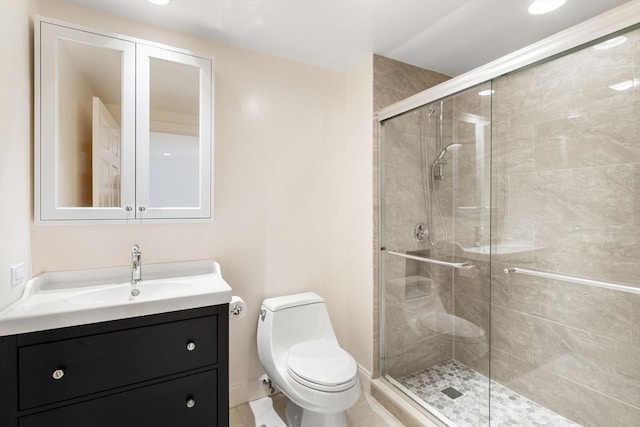 bathroom featuring vanity, an enclosed shower, and toilet