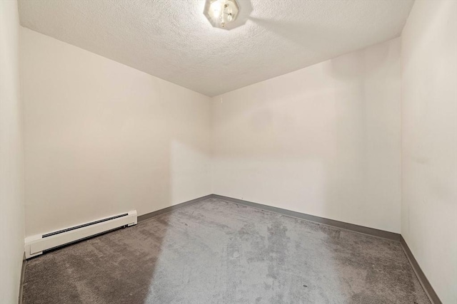 carpeted empty room with a textured ceiling, baseboards, and a baseboard heating unit