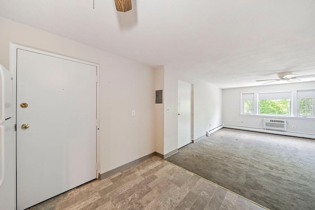 entryway with electric panel, ceiling fan, light carpet, and baseboards