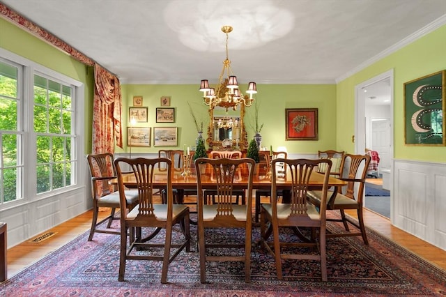 29 Stop River Rd, Norfolk, MA 02056 - dining area featuring wood finished floors, a chandelier, crown molding, and a decorative wall
