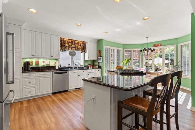 29 Stop River Rd, Norfolk, MA 02056 - kitchen with appliances with stainless steel finishes, a breakfast bar area, dark countertops, plenty of natural light, and recessed lighting