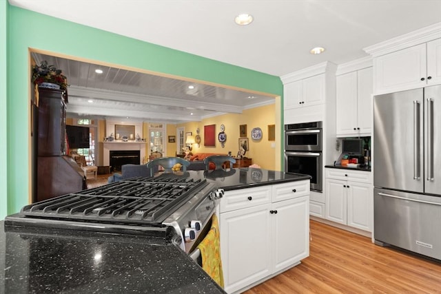 29 Stop River Rd, Norfolk, MA 02056 - kitchen with appliances with stainless steel finishes, ornamental molding, a fireplace, white cabinetry, and open floor plan