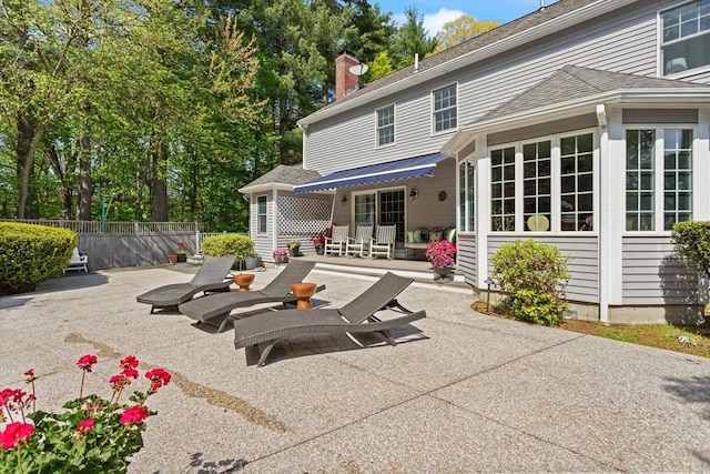 29 Stop River Rd, Norfolk, MA 02056 - back of house with a patio, fence, and a chimney