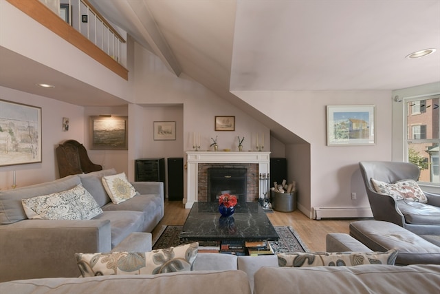 living room with light hardwood / wood-style floors, a baseboard heating unit, a brick fireplace, and vaulted ceiling with beams