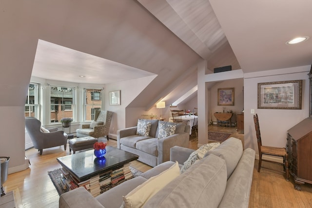 living room featuring vaulted ceiling and light hardwood / wood-style floors