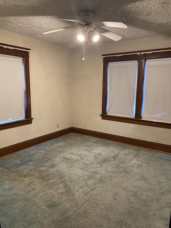 7 Exchange St, Westfield, MA 01085 - carpeted spare room featuring ceiling fan, baseboards, and a textured ceiling