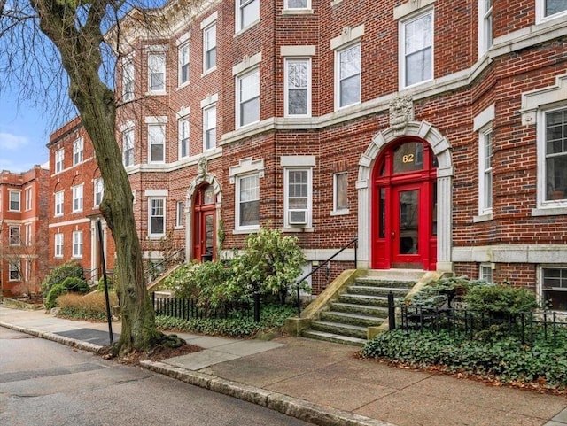 doorway to property featuring brick siding