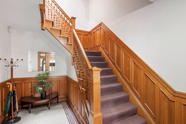 stairs featuring carpet flooring and wainscoting