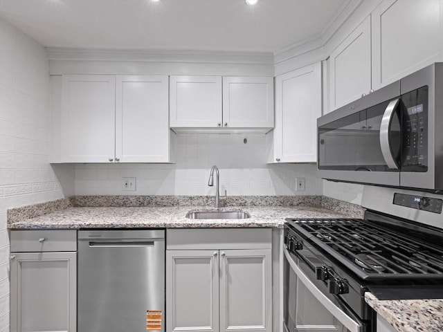 48 Decarolis Dr Unit 48, Tewksbury, MA 01876 - kitchen with appliances with stainless steel finishes, white cabinetry, light stone countertops, and decorative backsplash
