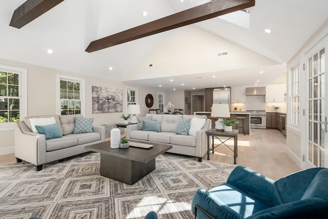 living room featuring beamed ceiling, light wood finished floors, high vaulted ceiling, and recessed lighting
