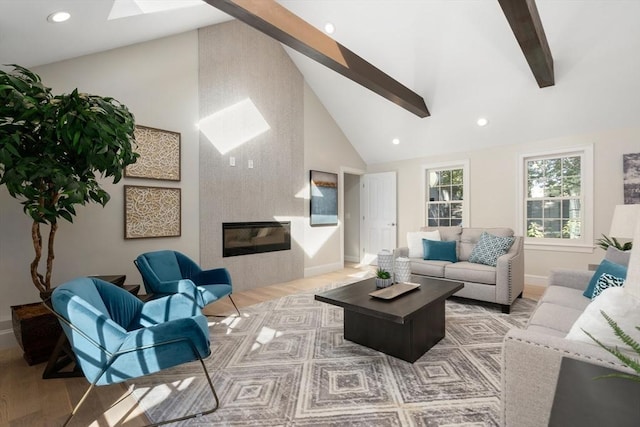 living area featuring a skylight, beamed ceiling, light wood-style floors, recessed lighting, and baseboards