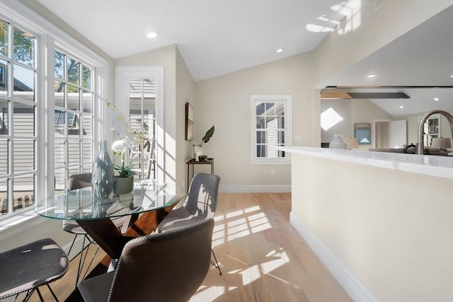 dining area with vaulted ceiling, light wood-type flooring, baseboards, and recessed lighting