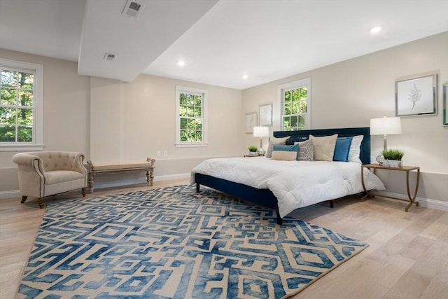 bedroom featuring wood finished floors, baseboards, and recessed lighting