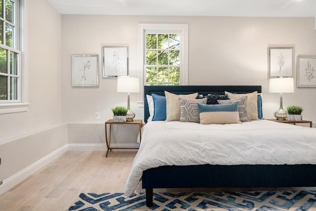 bedroom featuring wood finished floors and baseboards