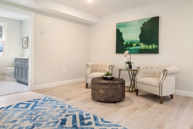 living area with light wood-style floors and baseboards