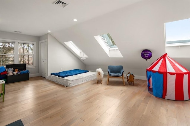 bedroom with a skylight, recessed lighting, wood finished floors, lofted ceiling, and baseboards